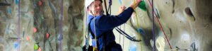 A man climbing on a mountain smiling