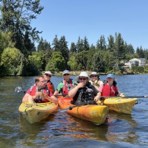 PTPs Sam, Sarina, and Faith kayaking with staff Caroline, Henry, and volunteer Monica